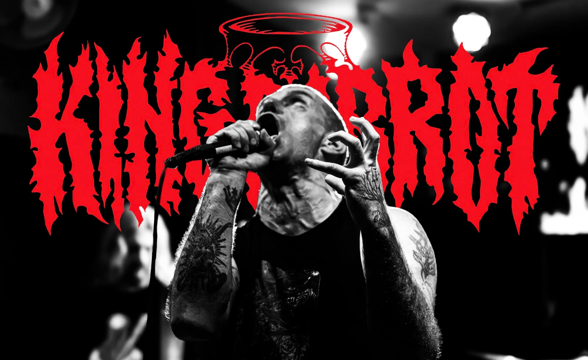King Parrot's vocalist screaming into a microphone, in black and white, in front of the band's red logo