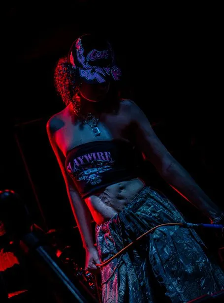 Justice for Lilith’s vocalist mid-song under red stage lights