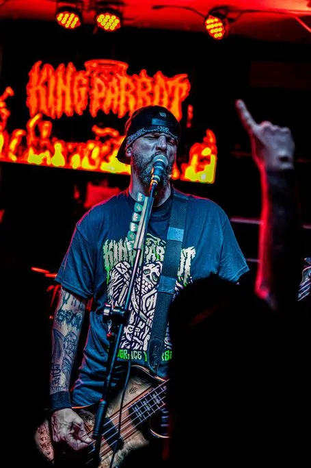 King Parrot’s bassist singing in front of the band’s flaming backdrop