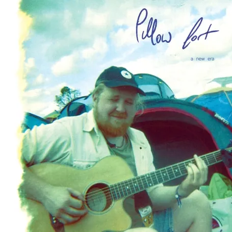 Single artwork for “A New Era”: a man in a cap playing acoustic guitar at a festival campsite